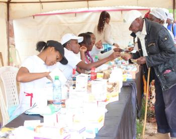 Patients receive free drugs after treatment during a free medical camp at Turuturu Secondary School 