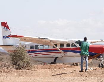 Pastor Francis standing by the Sesia airstrip as the plane landed.