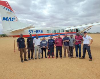 A group of ophthalmologists from the Fred Hollows Foundation pictured alongside Pilot Daniel at Madera Airstrip.