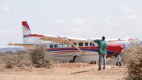 Pastor Francis standing by the Sesia airstrip as the plane landed.