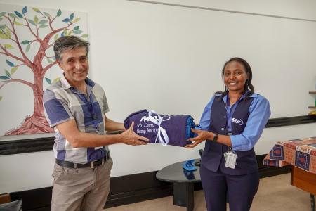 Leon is presented with a gift by Faith Susan, MAF Kenya's Country Director during his farewell.