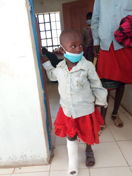 Neyeso walking out of CURE Kijabe Hospital with a cast on her foot