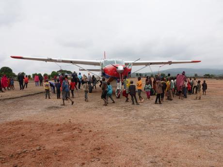 Kids excited about the MAF plane landing in Enairebuk - March 2023