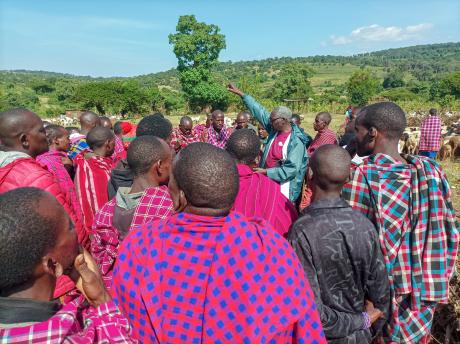 Dr. Mandieka Leading Prayers with a Gathering of Maasai Men