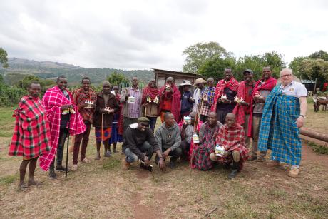 Joyful Maasai herders proudly display the medication they have obtained for their cattle.