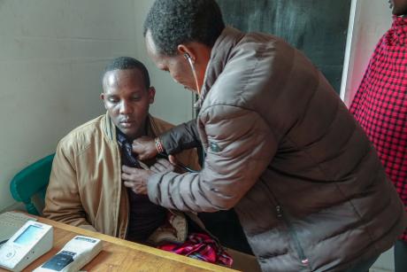 The clinical officer examines James before offering treatment .