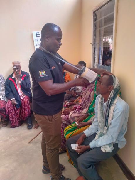 An ophthalmologist evaluates a man's eye prior to making a diagnosis at the surgical clinic