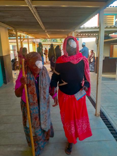 Women walking from the clinic after undergoing surgery to restore their sight