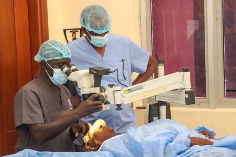 Ophthalmologists preparing a patient for eye surgery.